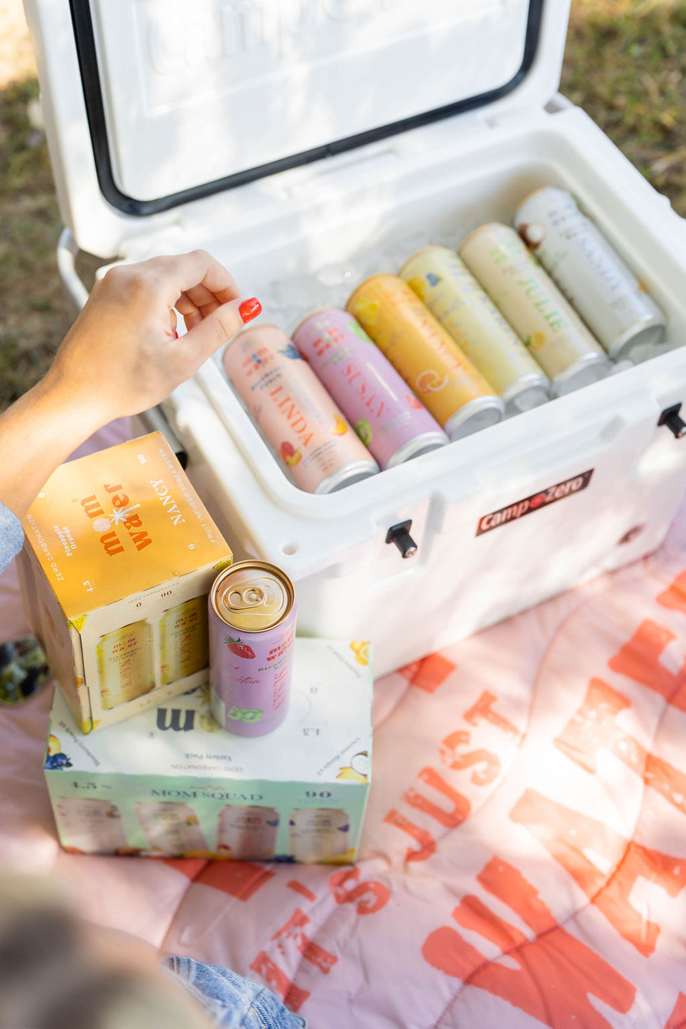 Picture of the variety pack of Mom Water in a cooler.